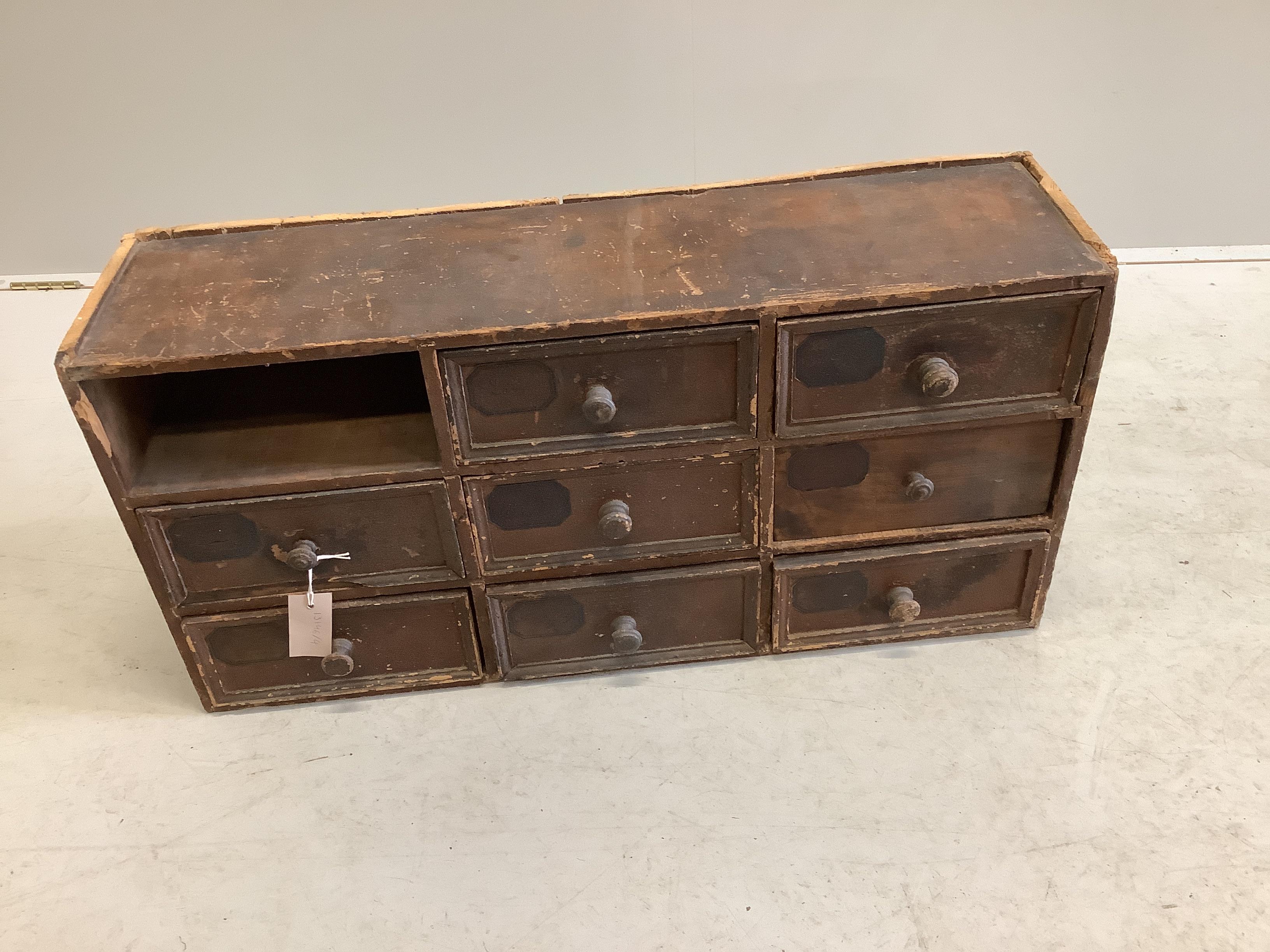 A painted pine nest of eight drawers, width 78cm, depth 22cm, height 38cm